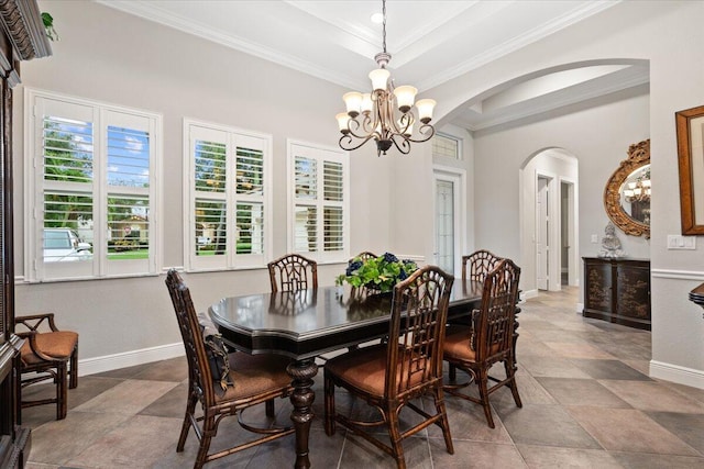 9926 SW Nuova Way, Port Saint Lucie, FL 34986 - dining room featuring arched walkways, a chandelier, crown molding, baseboards, and a tray ceiling