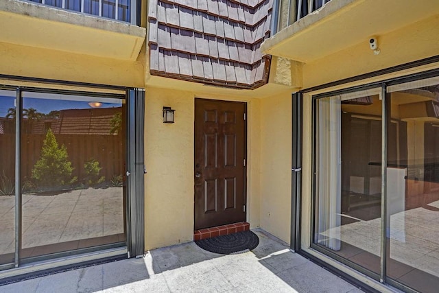 973 Springdale Cir Unit 97-C, Palm Springs, FL 33461 - doorway to property with stucco siding and a security system