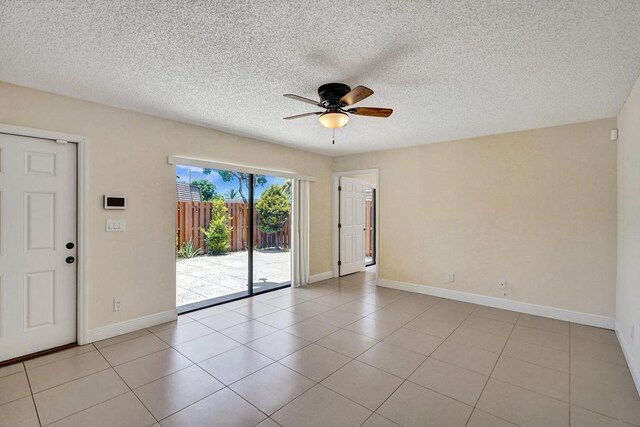 973 Springdale Cir Unit 97-C, Palm Springs, FL 33461 - empty room with ceiling fan, baseboards, light tile patterned floors, and a textured ceiling
