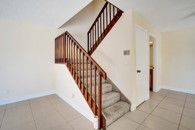 973 Springdale Cir Unit 97-C, Palm Springs, FL 33461 - stairway with tile patterned flooring, baseboards, and a textured ceiling