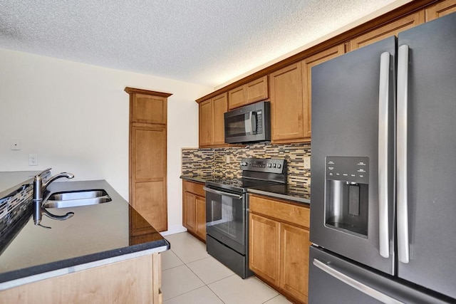 973 Springdale Cir Unit 97-C, Palm Springs, FL 33461 - kitchen featuring black appliances, dark countertops, light tile patterned flooring, decorative backsplash, and a textured ceiling