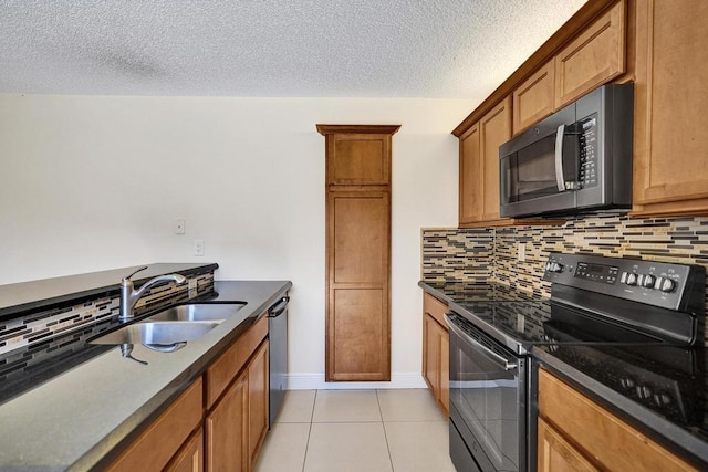 973 Springdale Cir Unit 97-C, Palm Springs, FL 33461 - kitchen with black appliances, a sink, backsplash, light tile patterned floors, and a textured ceiling