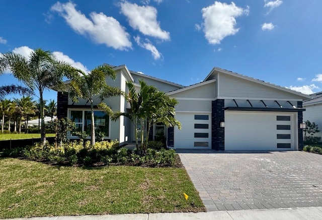 10705 Stellar Cir Unit 56, Palm Beach Gardens, FL 33412 - contemporary home featuring an attached garage, decorative driveway, and a front yard