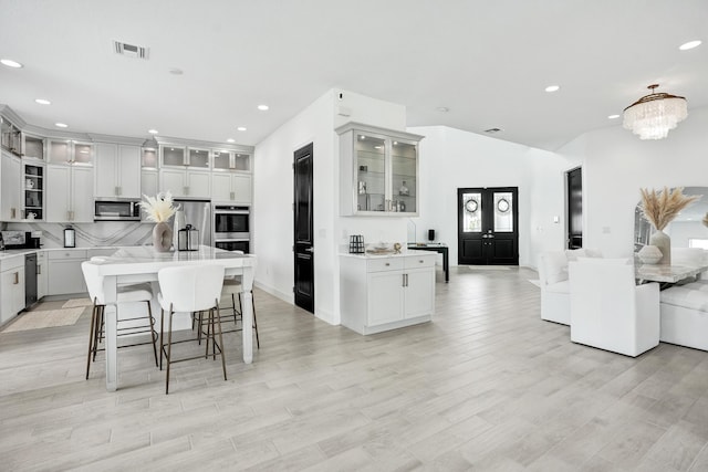 5609 Zestar Ln, The Acreage, FL 33470 - kitchen featuring stainless steel appliances, recessed lighting, decorative backsplash, a kitchen island, and light countertops
