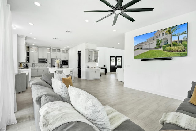 5609 Zestar Ln, The Acreage, FL 33470 - living room with recessed lighting, light wood-style floors, ceiling fan, and baseboards