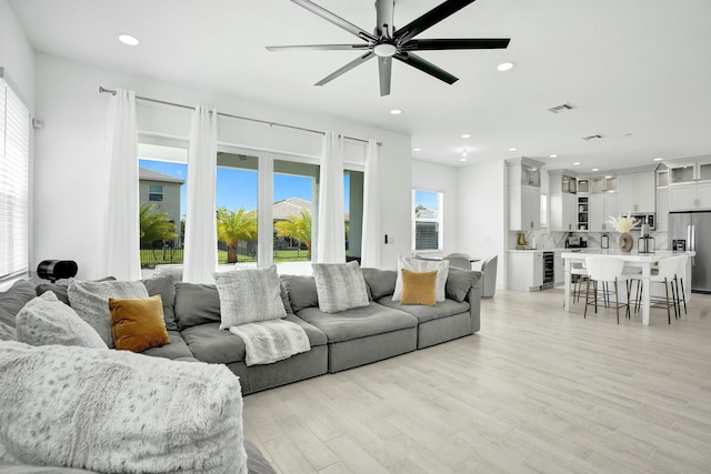 5609 Zestar Ln, The Acreage, FL 33470 - living area with ceiling fan, recessed lighting, light wood-style flooring, and wine cooler