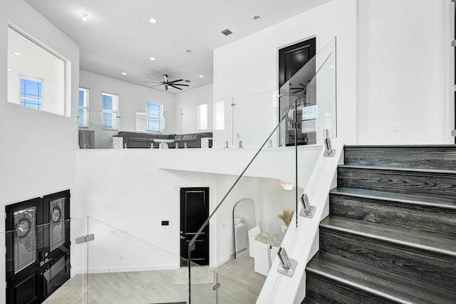 5609 Zestar Ln, The Acreage, FL 33470 - stairway with a ceiling fan, recessed lighting, a towering ceiling, and wood finished floors