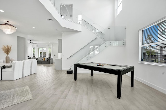 5609 Zestar Ln, The Acreage, FL 33470 - game room with light wood-type flooring, ceiling fan, recessed lighting, baseboards, and a towering ceiling
