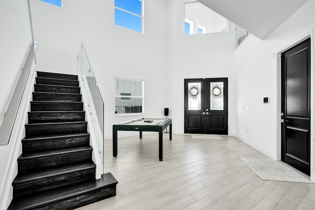 5609 Zestar Ln, The Acreage, FL 33470 - entryway featuring stairs, a towering ceiling, healthy amount of natural light, and light wood-style flooring