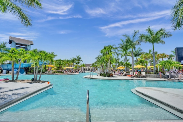 5609 Zestar Ln, The Acreage, FL 33470 - community pool featuring a patio area and a water slide