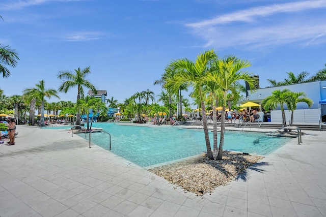 5609 Zestar Ln, The Acreage, FL 33470 - community pool featuring a patio