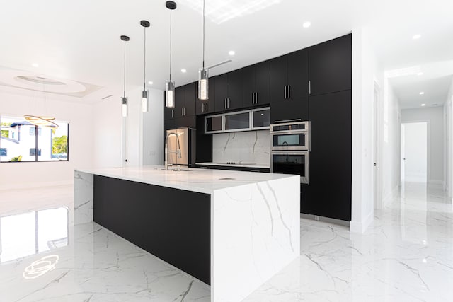 640 Marshall Rd, West Palm Beach, FL 33413 - kitchen with dark cabinetry, modern cabinets, a sink, stainless steel appliances, and a large island