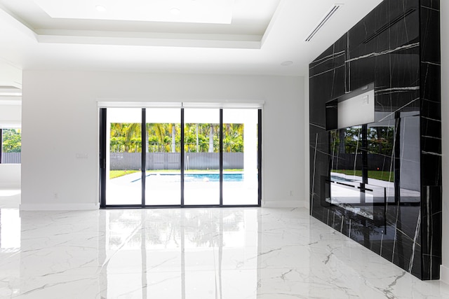 640 Marshall Rd, West Palm Beach, FL 33413 - unfurnished room with plenty of natural light, a raised ceiling, light marble finish flooring, and recessed lighting