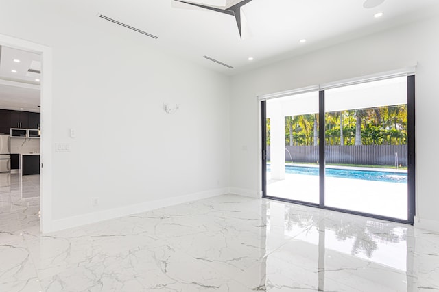 640 Marshall Rd, West Palm Beach, FL 33413 - spare room featuring marble tiled flooring, recessed lighting, and baseboards