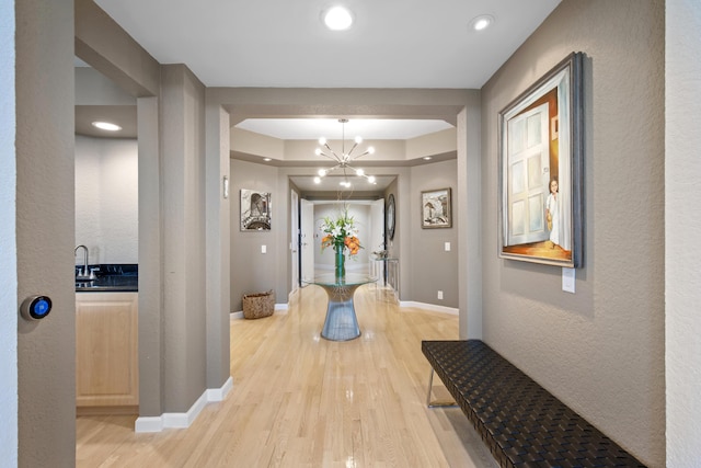 20310 Fairway Oaks Dr Unit 161, Boca Raton, FL 33434 - corridor featuring light wood-style floors, a chandelier, recessed lighting, and a tray ceiling