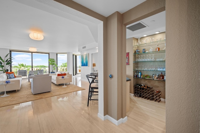 20310 Fairway Oaks Dr Unit 161, Boca Raton, FL 33434 - living room featuring wood finished floors, a textured wall, and expansive windows