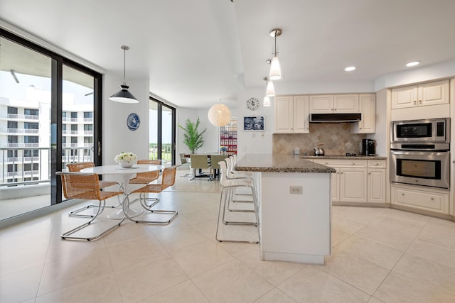 20310 Fairway Oaks Dr Unit 161, Boca Raton, FL 33434 - kitchen with appliances with stainless steel finishes, plenty of natural light, tasteful backsplash, stone counters, and recessed lighting