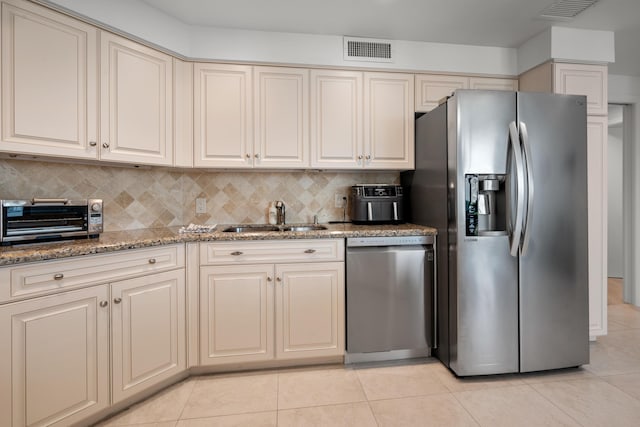 20310 Fairway Oaks Dr Unit 161, Boca Raton, FL 33434 - kitchen with appliances with stainless steel finishes, light tile patterned flooring, decorative backsplash, light stone counters, and cream cabinets