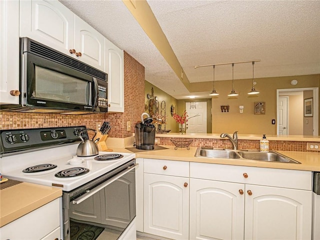 1590 S 42nd Cir Unit 106, Vero Beach, FL 32967 - kitchen with electric range, black microwave, a sink, white cabinets, and track lighting