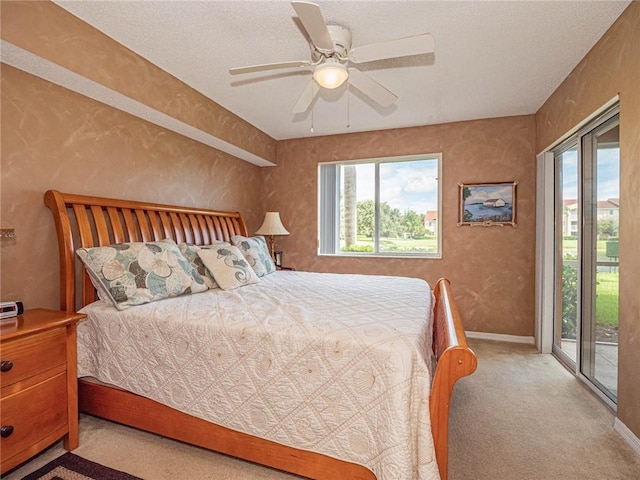 1590 S 42nd Cir Unit 106, Vero Beach, FL 32967 - bedroom with carpet, access to outside, multiple windows, a ceiling fan, and a textured wall
