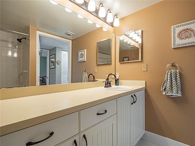 1590 S 42nd Cir Unit 106, Vero Beach, FL 32967 - full bath featuring vanity, tile patterned flooring, tiled shower, and baseboards