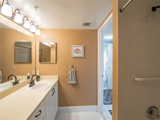 1590 S 42nd Cir Unit 106, Vero Beach, FL 32967 - full bathroom with baseboards, vanity, tile patterned flooring, and a shower