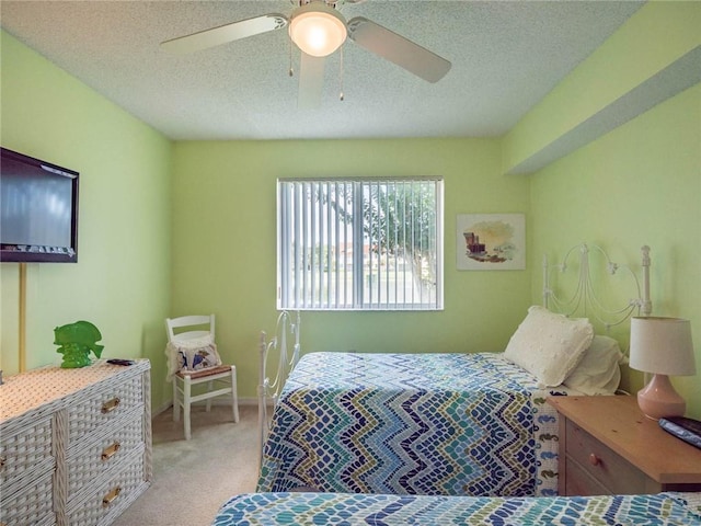 1590 S 42nd Cir Unit 106, Vero Beach, FL 32967 - bedroom featuring light carpet, a textured ceiling, a ceiling fan, and baseboards