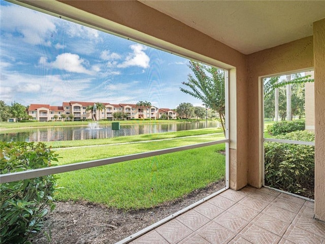1590 S 42nd Cir Unit 106, Vero Beach, FL 32967 - unfurnished sunroom with a water view, a residential view, and healthy amount of natural light