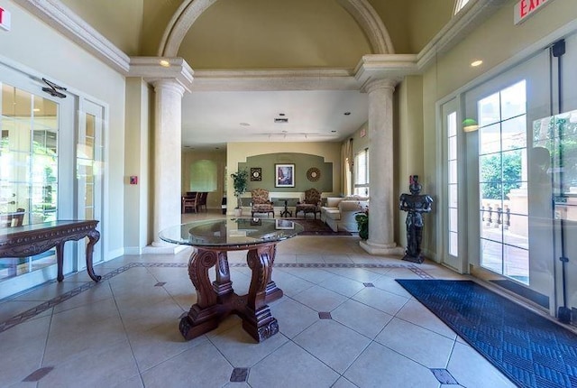 1590 S 42nd Cir Unit 106, Vero Beach, FL 32967 - tiled foyer with decorative columns, arched walkways, and baseboards