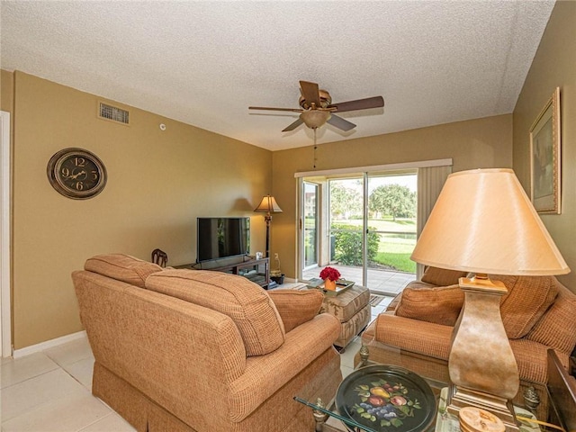 1590 S 42nd Cir Unit 106, Vero Beach, FL 32967 - living room with ceiling fan, a textured ceiling, light tile patterned flooring, and baseboards