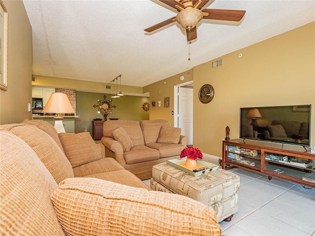 1590 S 42nd Cir Unit 106, Vero Beach, FL 32967 - living room featuring a ceiling fan, light tile patterned flooring, and a textured ceiling