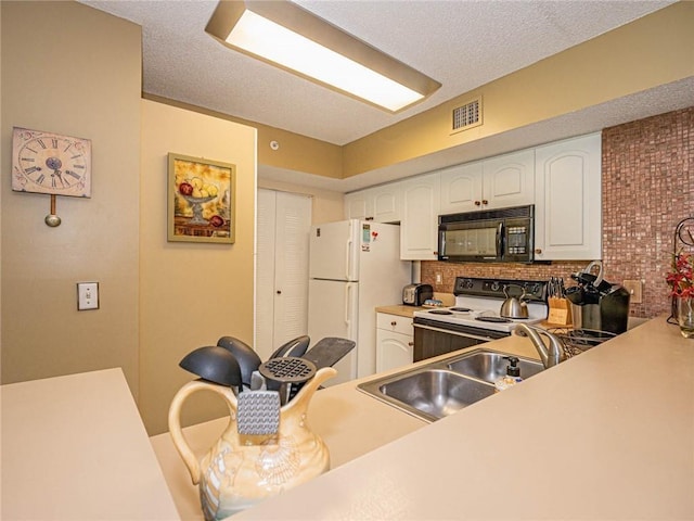 1590 S 42nd Cir Unit 106, Vero Beach, FL 32967 - kitchen with white appliances, white cabinets, a sink, and tasteful backsplash