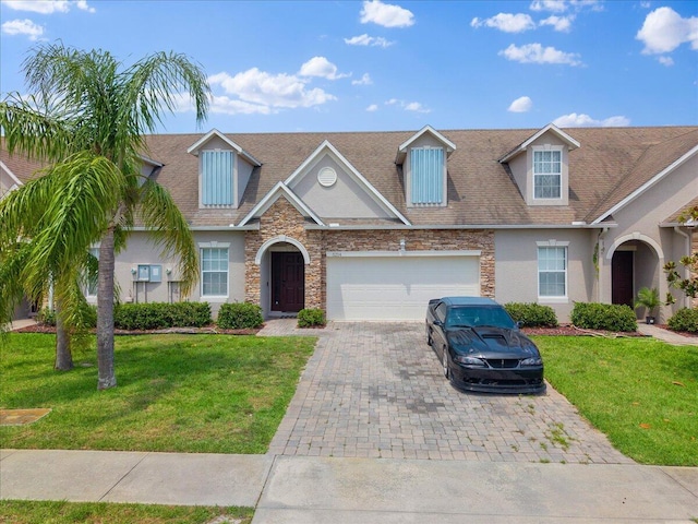 5214 Manciano St, Fort Pierce, FL 34951 - view of front facade with decorative driveway, stone siding, a garage, stucco siding, and a front yard