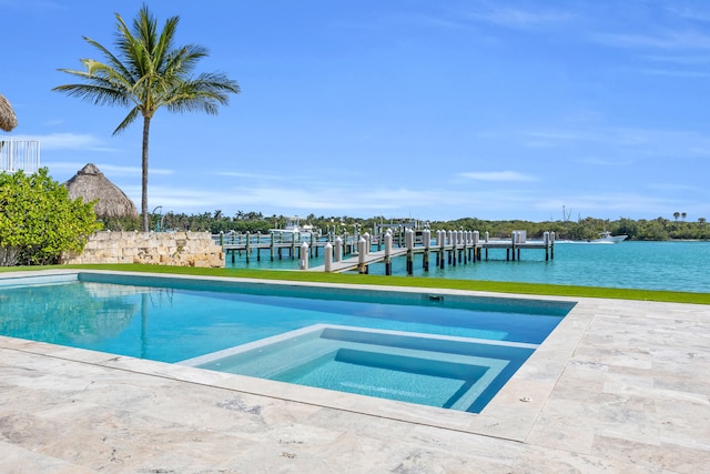 18119 SE Federal Hwy, Tequesta, FL 33469 - view of swimming pool featuring a boat dock, a pool with connected hot tub, and a water view
