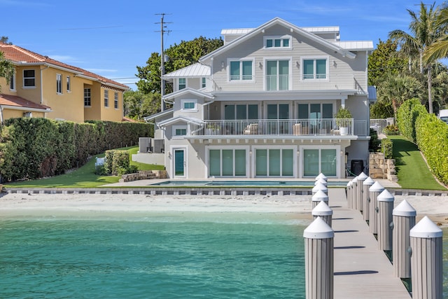 18119 SE Federal Hwy, Tequesta, FL 33469 - back of property featuring view of water and beach, a balcony, metal roof, and a standing seam roof