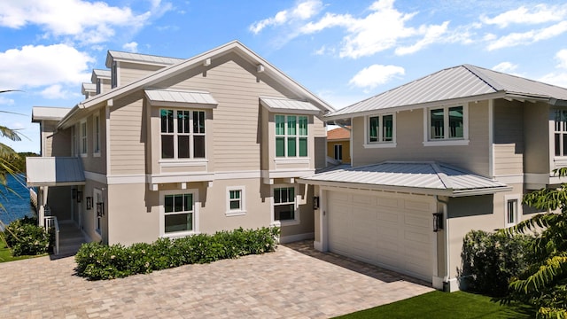 18119 SE Federal Hwy, Tequesta, FL 33469 - view of front facade with metal roof, decorative driveway, and a standing seam roof