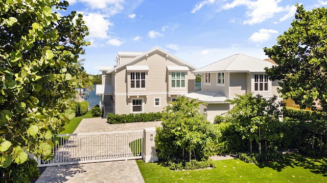 18119 SE Federal Hwy, Tequesta, FL 33469 - view of front of house with a gate, a fenced front yard, and stucco siding