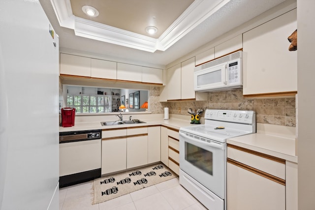 5200 SE Seascape Way Unit 201, Stuart, FL 34997 - kitchen featuring white appliances, a sink, light countertops, a tray ceiling, and crown molding