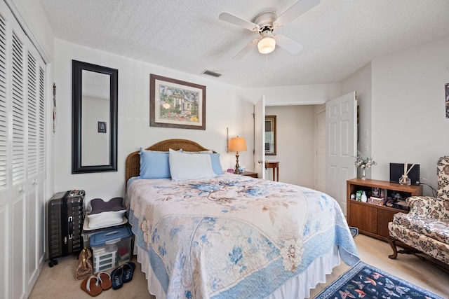 5200 SE Seascape Way Unit 201, Stuart, FL 34997 - bedroom with carpet floors, a textured ceiling, a closet, and a ceiling fan
