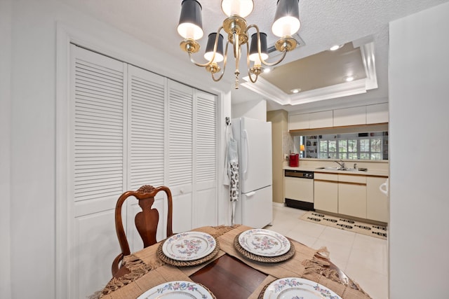 5200 SE Seascape Way Unit 201, Stuart, FL 34997 - dining area featuring a raised ceiling, a chandelier, light tile patterned flooring, and crown molding