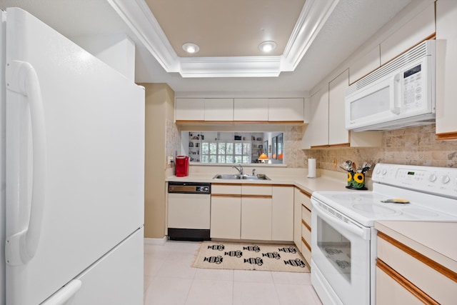 5200 SE Seascape Way Unit 201, Stuart, FL 34997 - kitchen featuring white appliances, a tray ceiling, light countertops, light tile patterned flooring, and ornamental molding