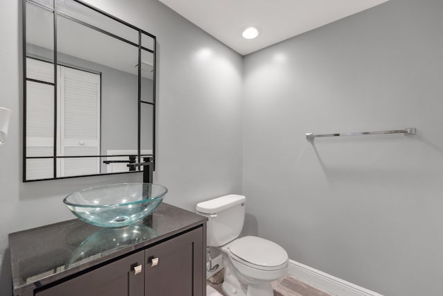 3665 Sliver Lace Ln Unit 80, Boynton Beach, FL 33436 - half bathroom featuring vanity, toilet, and baseboards