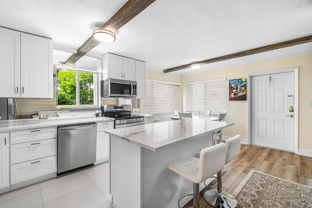 2020 Lake Osborne Dr Unit 10, Lake Worth, FL 33461 - bedroom featuring wood finished floors, beam ceiling, ornamental molding, and a city view