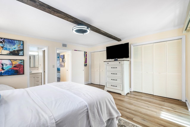 2020 Lake Osborne Dr Unit 10, Lake Worth, FL 33461 - bedroom featuring multiple closets, crown molding, light wood-style flooring, and beam ceiling