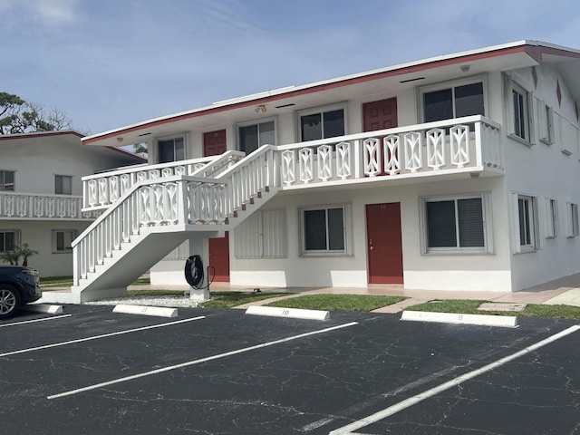 2020 Lake Osborne Dr Unit 10, Lake Worth, FL 33461 - view of property with uncovered parking and stairway