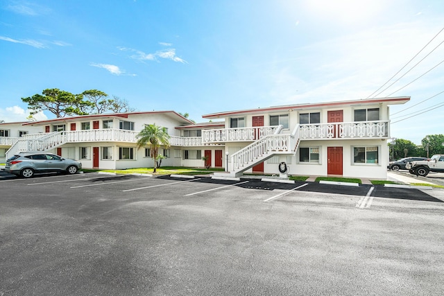 2020 Lake Osborne Dr Unit 10, Lake Worth, FL 33461 - view of front of home with uncovered parking, stairs, and stucco siding