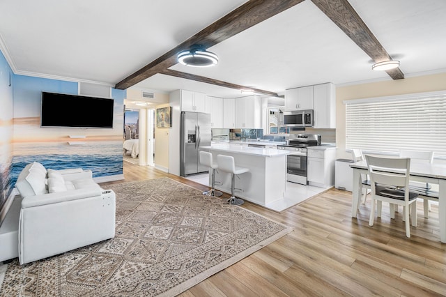 2020 Lake Osborne Dr Unit 10, Lake Worth, FL 33461 - kitchen featuring appliances with stainless steel finishes, white cabinets, light countertops, light wood-style floors, and beamed ceiling