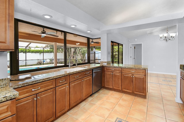515 SE Nome Dr, Port Saint Lucie, FL 34984 - kitchen featuring dishwasher, a sink, a ceiling fan, brown cabinets, and healthy amount of natural light