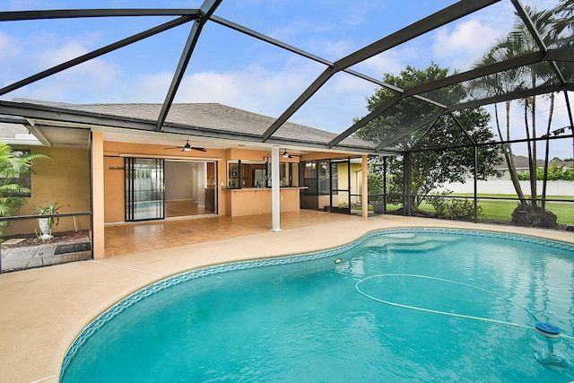 515 SE Nome Dr, Port Saint Lucie, FL 34984 - swimming pool featuring a patio area, a ceiling fan, and a lanai