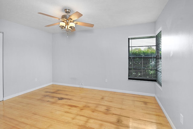 515 SE Nome Dr, Port Saint Lucie, FL 34984 - unfurnished room with ceiling fan, wood finished floors, and baseboards